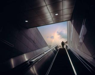 Umělecká fotografie Businessman on escalator moving towards sky, EschCollection,