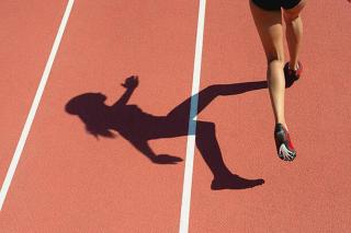 Umělecká fotografie Female athlete running on track, low, PhotoAlto/Odilon Dimier,