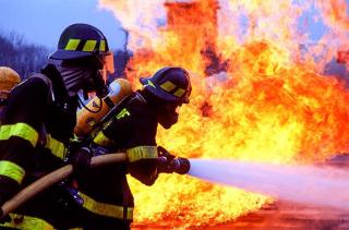 Umělecká fotografie Firemen fighting blaze with hose., Ted Horowitz Photography,