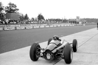 Umělecká fotografie Graham Hill in a BRM p61 monocoque in the pits, 1963,